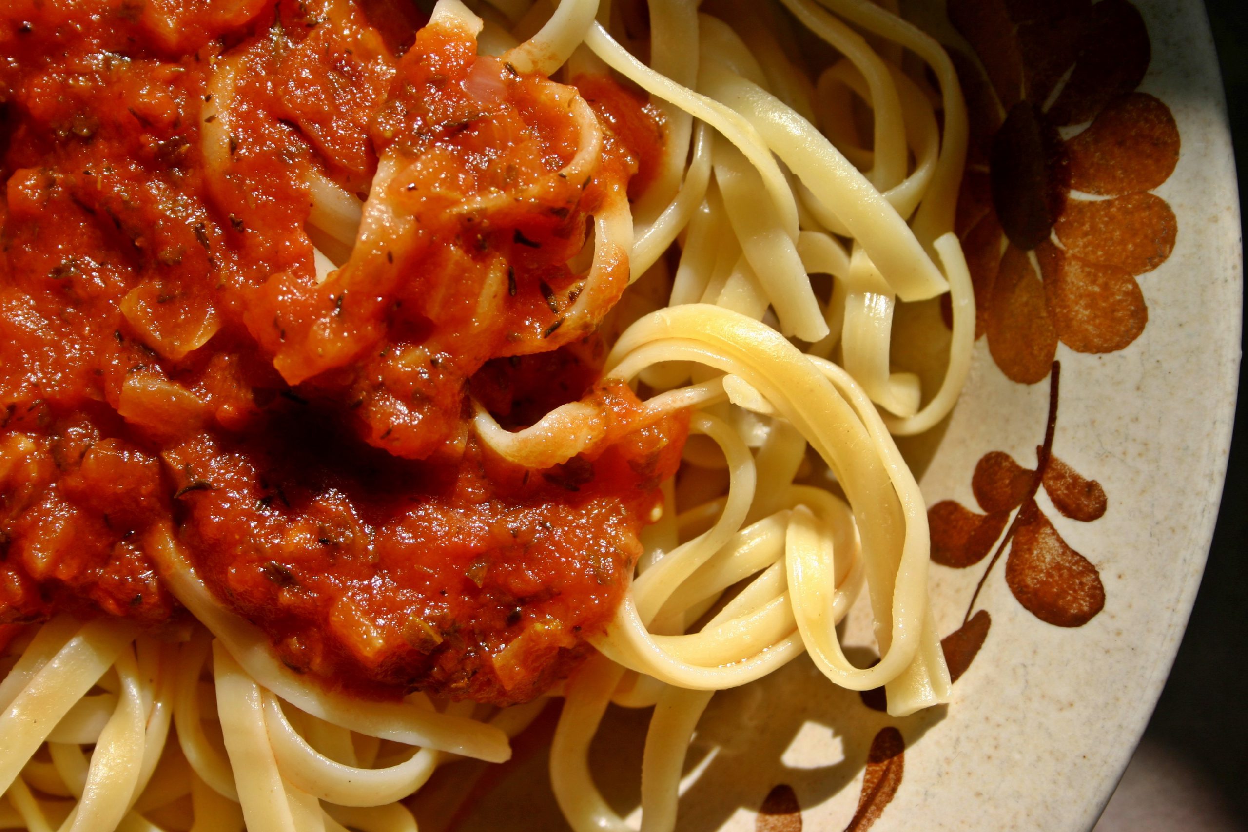 Plate of pasta with sauce.